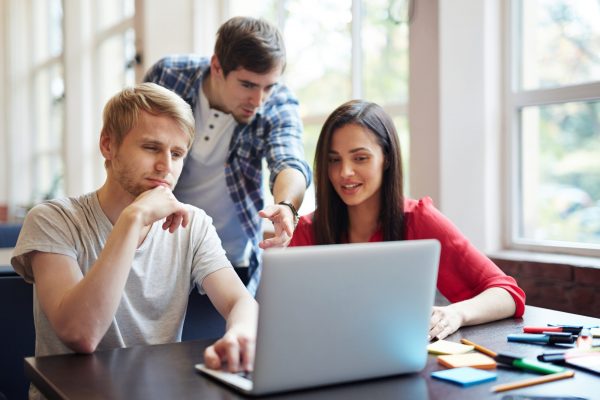 Group of teenage students discussing new educational video course at break